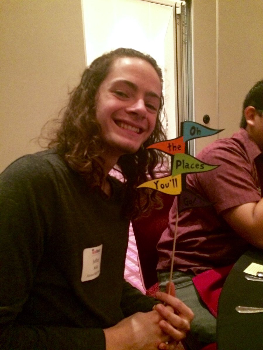student poses with Dr. Seuss themed centerpiece at Grad Day 2017