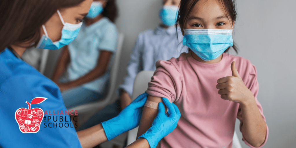 photo of nurse administering a vaccine to a child