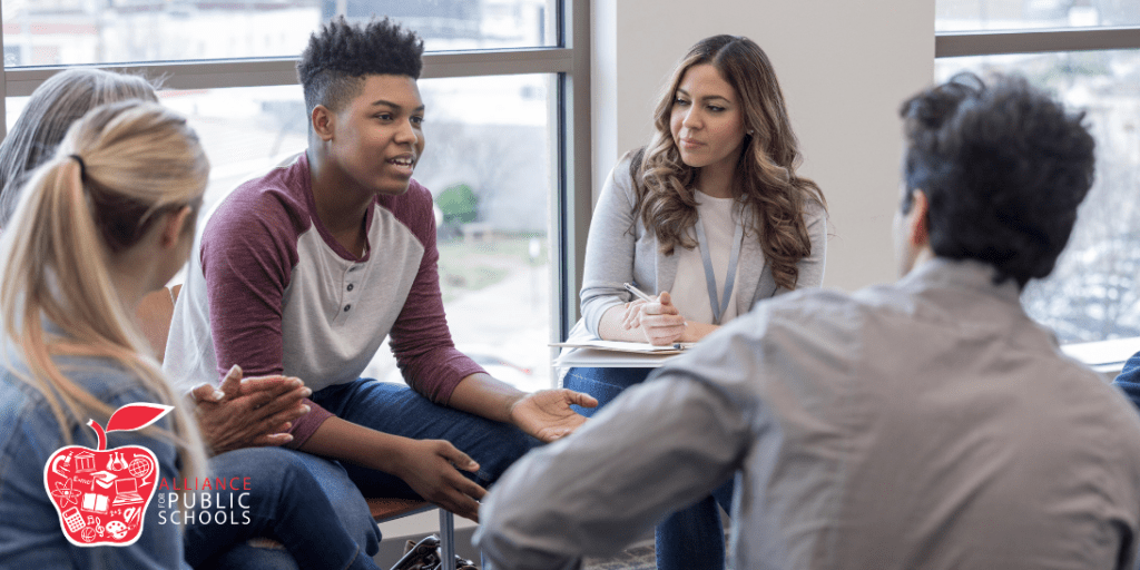 photo of students talking with administrator