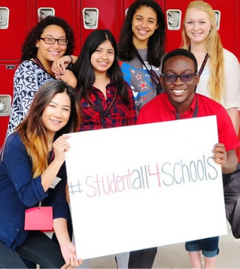 students holding a studentall4schools poster